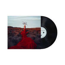 Cargar imagen en el visor de la galería, Vinyl record with a cover featuring a person in a red dress against a landscape.