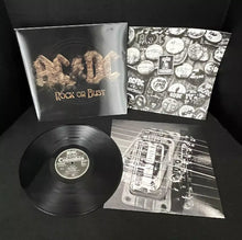 Cargar imagen en el visor de la galería, AC/DC vinyl record set with cover and poster on a dark surface