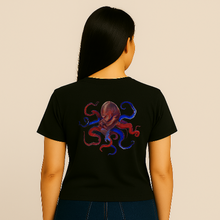 Charger l&#39;image dans la galerie, Person wearing a black t-shirt with a colorful octopus design on the back against a beige background