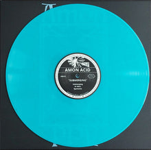 Load image into Gallery viewer, Turquoise vinyl record with a label on a black background