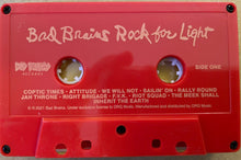 Load image into Gallery viewer, Red cassette tape with 'Bad Brains Rock for Light' text on a beige background