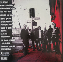 Charger l&#39;image dans la galerie, Album cover with band members on a street corner, featuring text and a red and black color scheme.