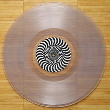 Cargar imagen en el visor de la galería, Vinyl record with a black and white spiral design on a wooden floor