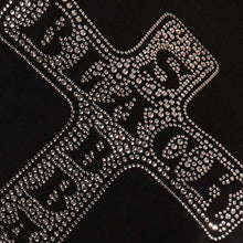 Load image into Gallery viewer, Decorative cross with rhinestone embellishments on a black background