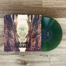 Load image into Gallery viewer, Vinyl record with cover titled 'Blackwater Holylight' on a wooden surface