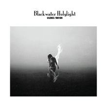 Charger l&#39;image dans la galerie, Blackwater Holylight album cover for &#39;Silence/Motion&#39; featuring a black and white photograph of a person with arms raised, standing on a misty landscape.