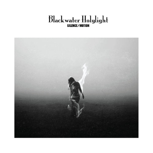 Blackwater Holylight album cover for 'Silence/Motion' featuring a black and white photograph of a person with arms raised, standing on a misty landscape.