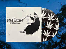 Load image into Gallery viewer, Card with black and white illustration of a figure and text 'Bong Wizard left hand pass' on a blue background with cannabis leaf pattern.