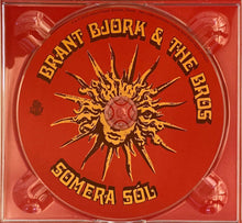 Load image into Gallery viewer, Red compact disc with sun design and text