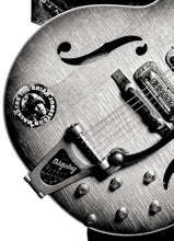 Load image into Gallery viewer, Close-up of a guitar with a logo and brand name on the body.