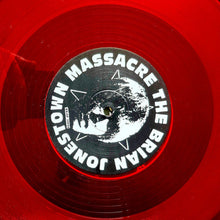 Load image into Gallery viewer, Close-up of a red vinyl record with a black label featuring text and graphics.