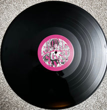 Cargar imagen en el visor de la galería, Vinyl record with a pink label featuring a person and abstract design on a textured surface.