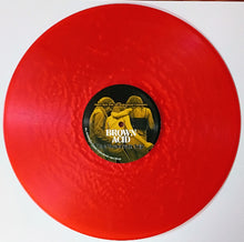 Charger l'image dans la galerie, Red vinyl record with a black label featuring text and images on a white background