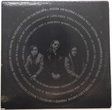 Charger l'image dans la galerie, Back cover of a vinyl record with text and black and white photo of three people.