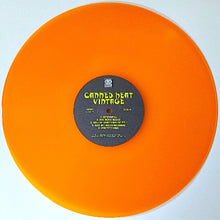 Load image into Gallery viewer, Orange vinyl record with a label on a white background