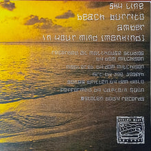 Cargar imagen en el visor de la galería, Album cover with sunset over water and text on a wooden background