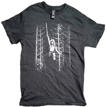 Cargar imagen en el visor de la galería, Black t-shirt with white graphic design of a person in a forest on a white background