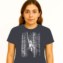 Cargar imagen en el visor de la galería, Person wearing a dark t-shirt with a graphic design of a person in a forest.
