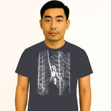 Cargar imagen en el visor de la galería, Man wearing a dark gray t-shirt with a graphic design of a person in a forest.