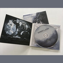 Load image into Gallery viewer, Open CD digipak showing band photo and the compact disc with the text &#39;COWBOYS &amp; ALIENS&#39;