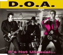 Charger l'image dans la galerie, Band performing with 'D.O.A.' text at the top and 'It's Not Unusual...' text at the bottom.
