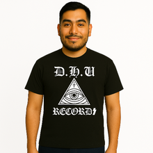 Load image into Gallery viewer, Man wearing a black t-shirt with &#39;D.H.U RECORDS&#39; design on a white background