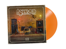 Load image into Gallery viewer, Vinyl record with orange disc and album cover featuring a room with musical instruments.