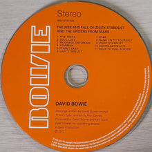 Load image into Gallery viewer, Orange CD with text and ' Bowie' logo on a wooden surface