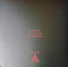 Cargar imagen en el visor de la galería, Album cover with text &#39;I. The Sun, II. Wanting, III. Zombies&#39; and a triangle logo on a dark background