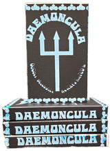 Cargar imagen en el visor de la galería, Stack of Daemoncula boxes with a trident symbol on a black background