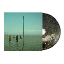 Charger l'image dans la galerie, CD with a cover featuring a person's hand holding a ring on a beach scene