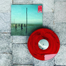 Load image into Gallery viewer, Red vinyl record with a green album cover on a stone surface