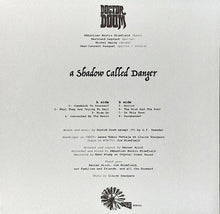 Cargar imagen en el visor de la galería, Back cover of a music album with text and branding on a light gray background