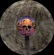 Charger l'image dans la galerie, Vinyl record with a colorful skull design on a wooden surface