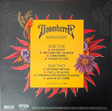 Charger l'image dans la galerie, The back cover of the Doomherr 'Bonegoat' vinyl record, featuring a bright yellow central label with track listings, surrounded by red and purple tropical flowers and an orange bird on a dark textured background.