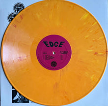 Load image into Gallery viewer, Orange vinyl record with a purple label on a light blue background