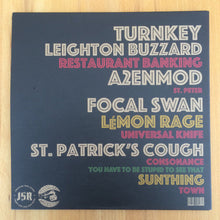 Charger l'image dans la galerie, Vinyl record cover with text on a wooden surface
