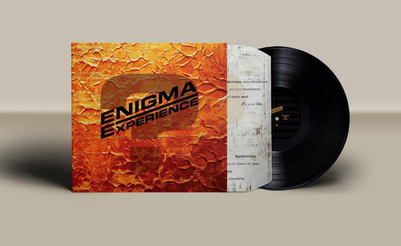 Vinyl record with textured cover labeled 'Enigma Experience' on a beige background