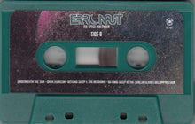 Charger l'image dans la galerie, Teal cassette tape with 'Erronaut' branding on a dark background