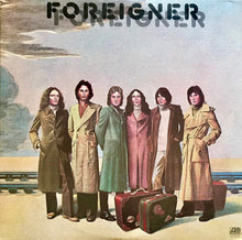 Load image into Gallery viewer, Album cover of 'Foreigner' with six people in coats and suitcases.