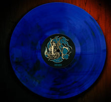 Load image into Gallery viewer, Blue vinyl record with a label on a wooden surface