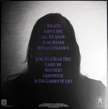 Load image into Gallery viewer, Person wearing a black hoodie with text on the back against a gray background