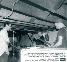 Load image into Gallery viewer, Black and white photo of a band practicing in a basement with musical instruments.