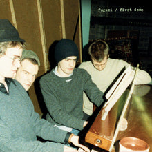 Load image into Gallery viewer, Four people around a piano with 'fugezi / first demo' text in the corner.