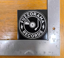 Cargar imagen en el visor de la galería, Sticker with 'FUZZORAMA RECORDS' design on a wooden surface with a ruler for scale.