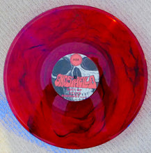 Charger l'image dans la galerie, Red vinyl record with a visible label on a textured surface