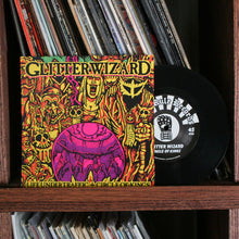 Cargar imagen en el visor de la galería, Vinyl record with colorful cover featuring 'Glimmer Wizard' on a shelf with other records.