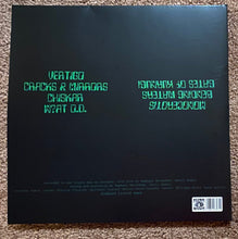Cargar imagen en el visor de la galería, Vinyl record cover with text on a dark background