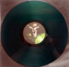 Cargar imagen en el visor de la galería, Green vinyl record with a gold label featuring a person on a brown surface