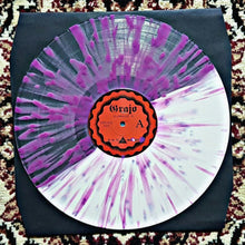 Load image into Gallery viewer, Vinyl record with a colorful splatter design on a textured surface